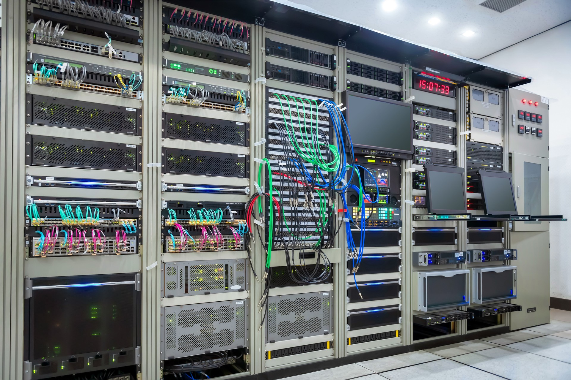 Modern servers are installed in the racks of the server room of the data center. Optical Internet cables are connected with the main router. Computer techologies.