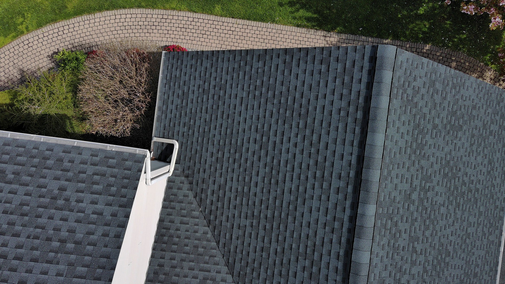 Residential rooftop and driveway in a sunny day. Top view